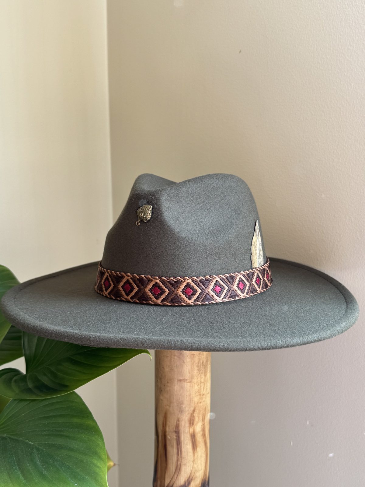 White fedora with silver pin and feather