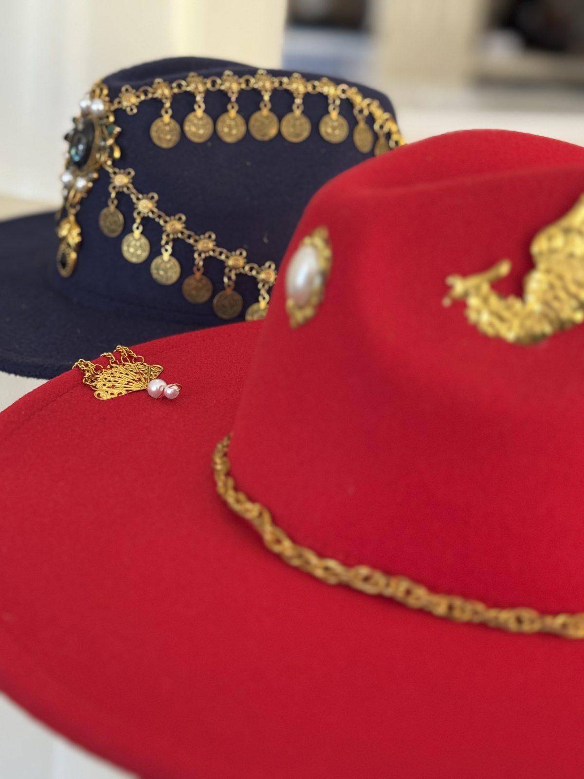 Red fedora with gold chain and emblem