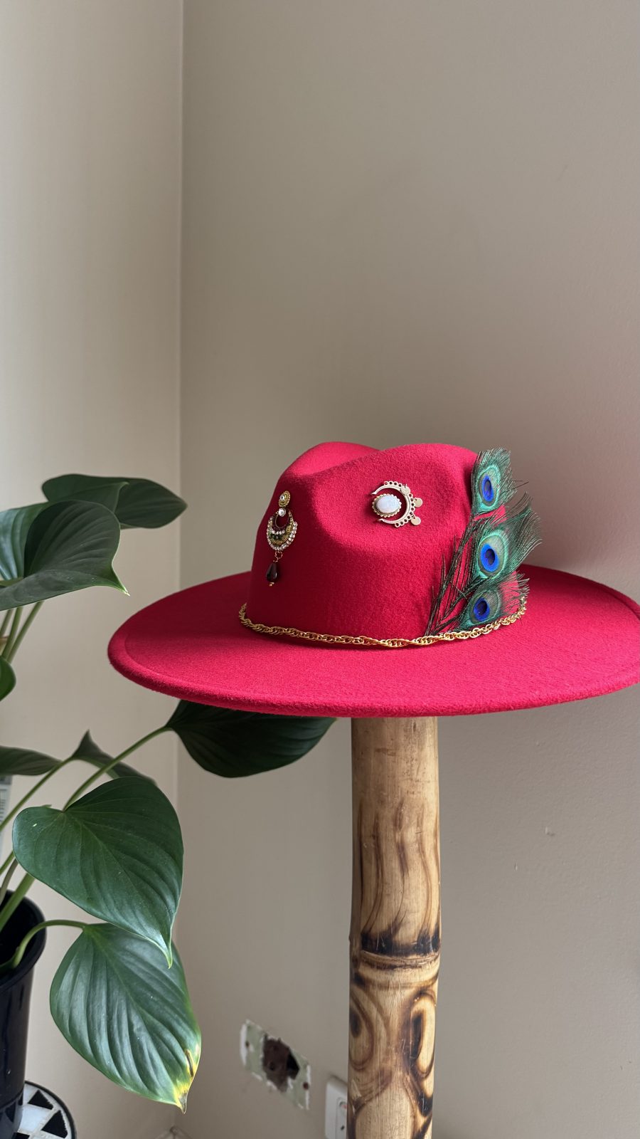 Hot pink fedora with turquoise stones and peacock feather